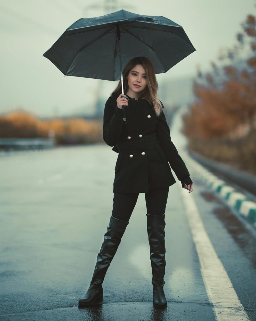 Woman Standing On A Road Holding An Umbrella